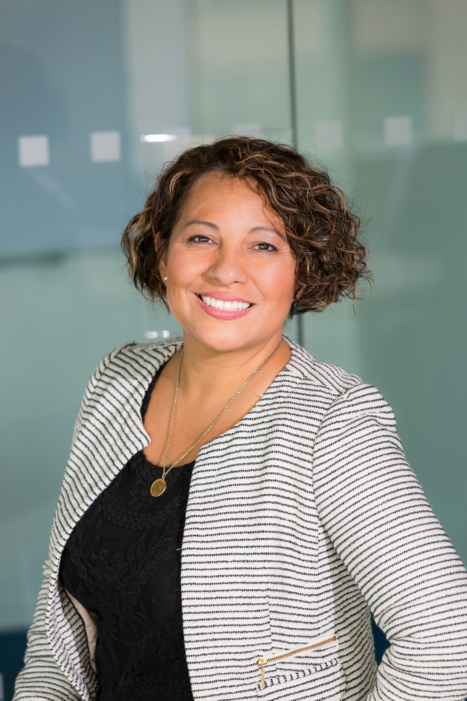 Smiling product leader in a striped blazer
