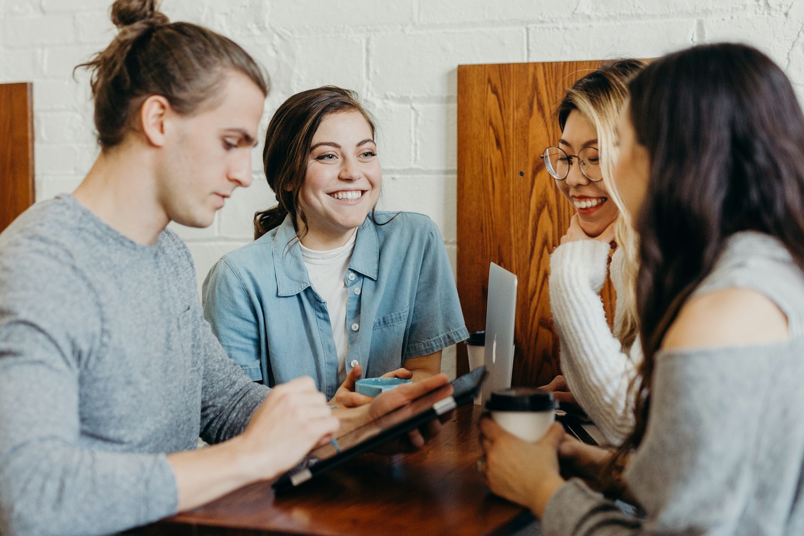 Product people talking over coffee, one of them smiling broadly